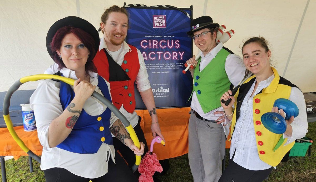 Kids and families learning circus skills at the festival's Circus School.
