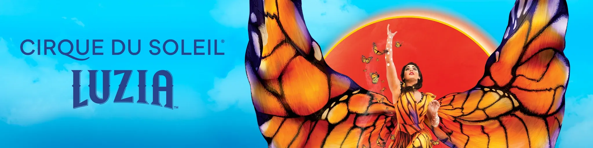 Cirque du Soleil LUZIA — a performer in a butterfly-winged costume reaching skyward against a red sun.